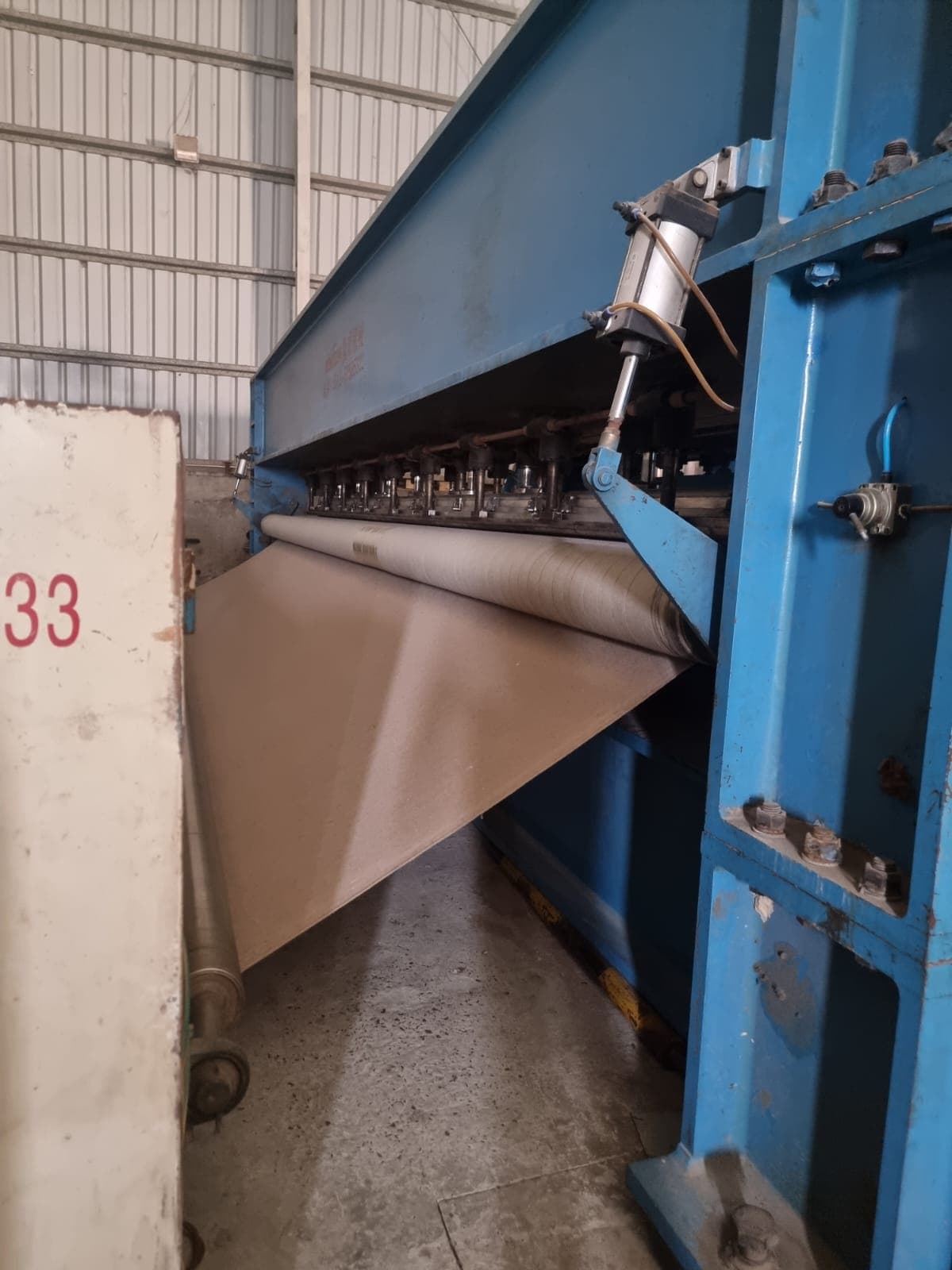 High-speed pneumatic cross-lapper feeding web into needle loom